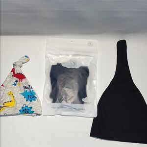 Two baby hats and an unopened baby onesie